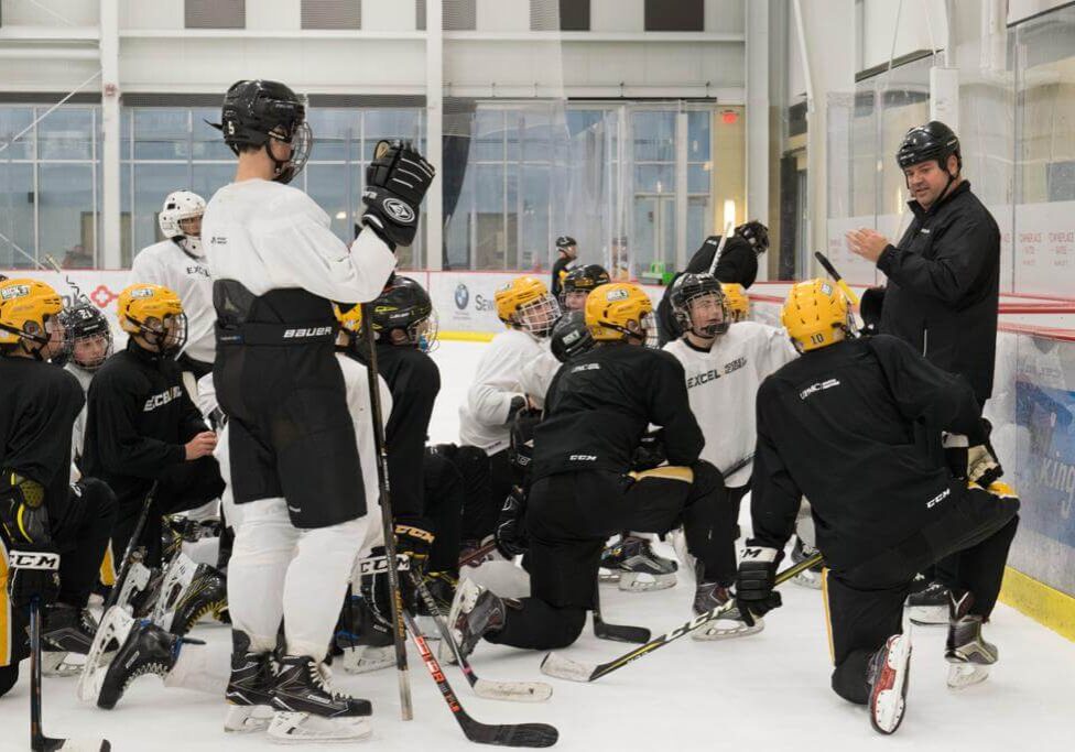 Coach Mueller reviewing daily practice plan