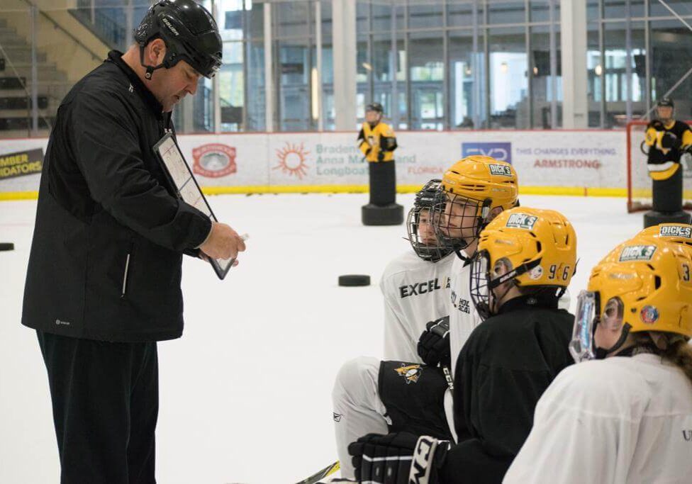 Coach Mueller reviewing daily practice plan